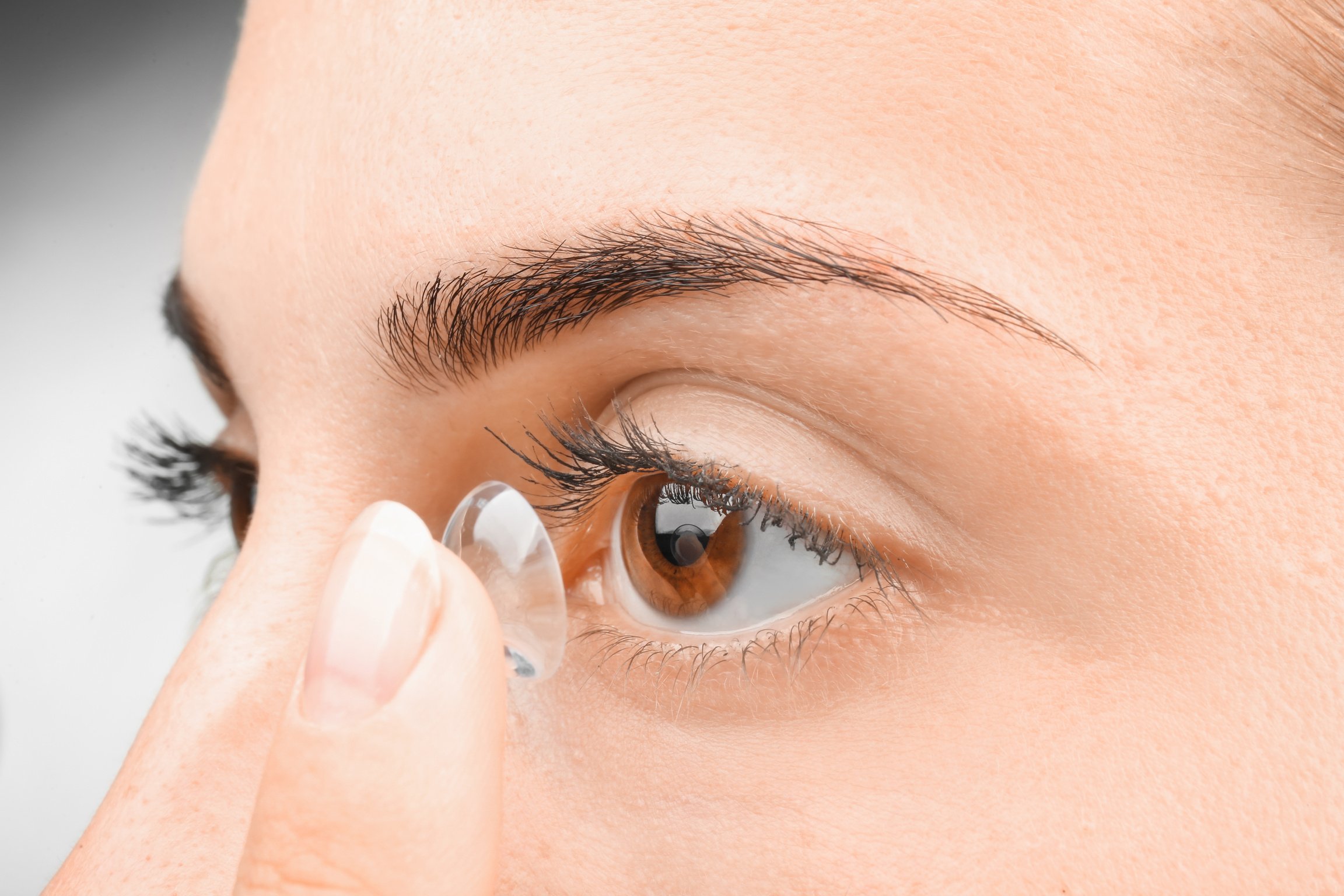 Young Woman Putting Contact Lens