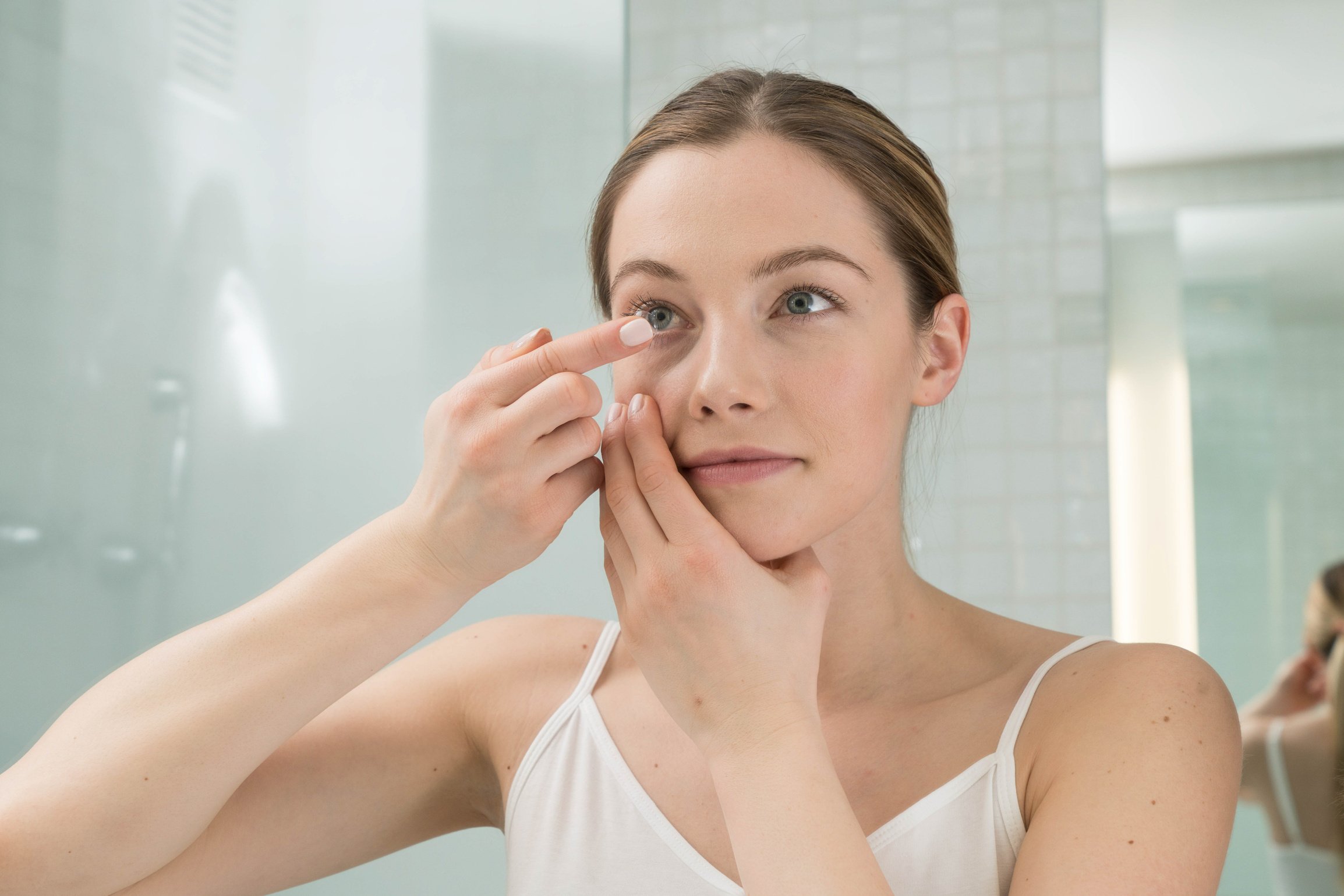 Woman Putting on Contact Lens